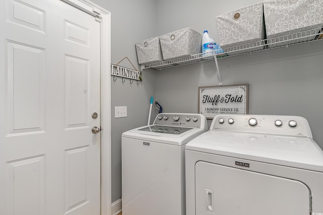 clothes washing area with washing machine and clothes dryer