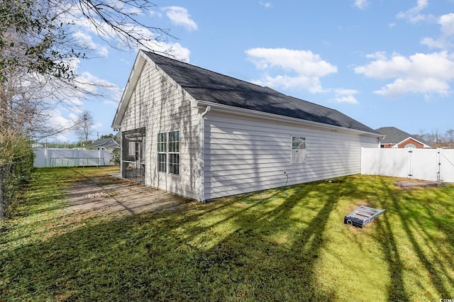 view of side of home with a yard