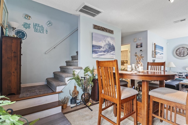 dining area with a textured ceiling