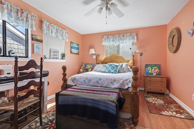 bedroom with ceiling fan and wood-type flooring