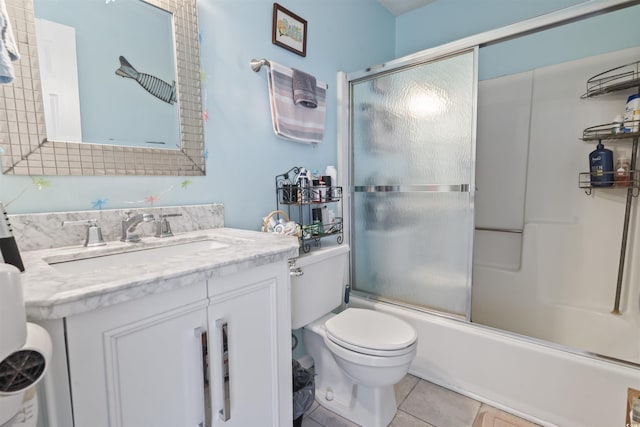 full bathroom featuring tile patterned flooring, vanity, toilet, and enclosed tub / shower combo