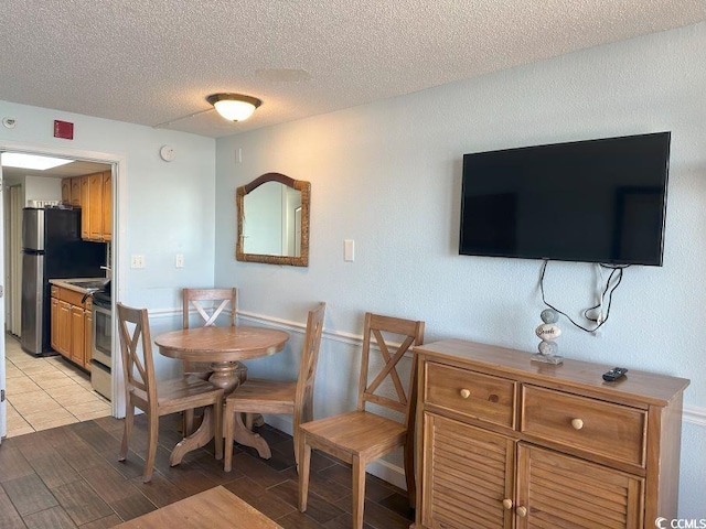 dining space featuring a textured ceiling