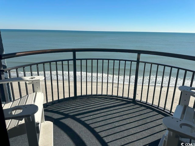 balcony featuring a beach view and a water view