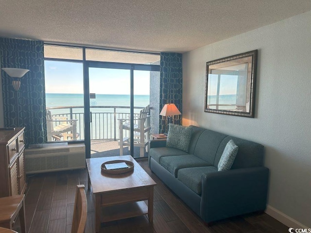 living room with floor to ceiling windows, a water view, a textured ceiling, dark hardwood / wood-style flooring, and radiator heating unit