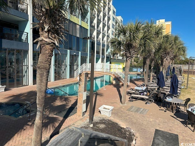 view of swimming pool with a patio area