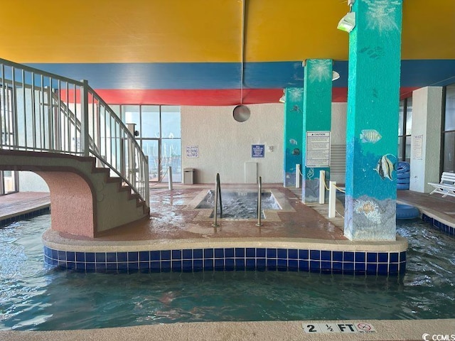 view of pool with an indoor hot tub