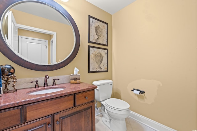 bathroom featuring tile patterned floors, toilet, and vanity