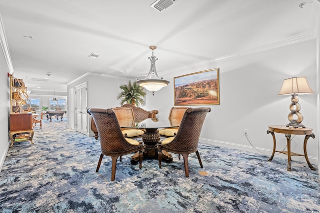 carpeted dining area with ornamental molding