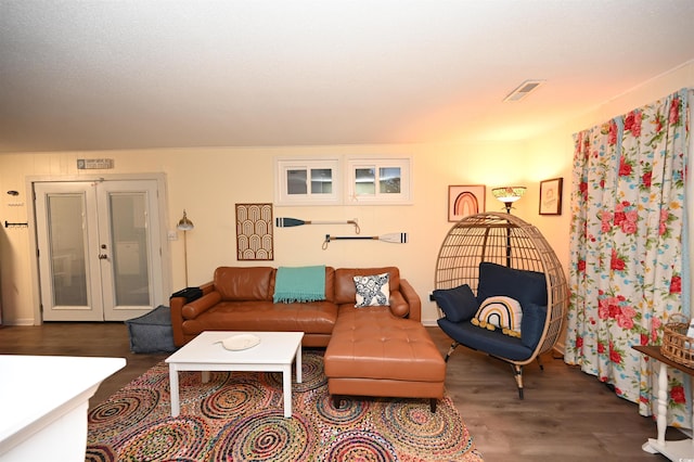 living room featuring dark wood-type flooring and french doors