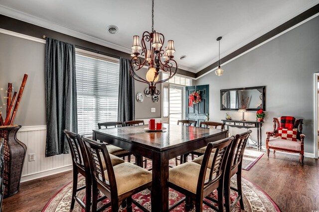 dining room with crown molding, dark hardwood / wood-style flooring, and a notable chandelier