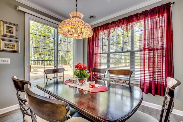 dining room featuring crown molding and hardwood / wood-style flooring