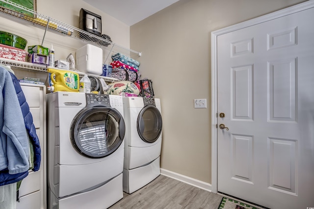 laundry room with light hardwood / wood-style floors and independent washer and dryer