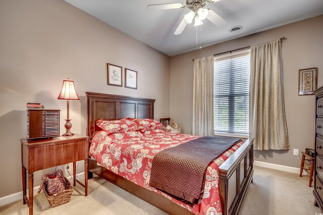 bedroom featuring carpet flooring, multiple windows, and ceiling fan