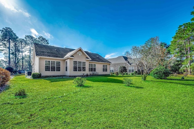 back of property featuring a lawn