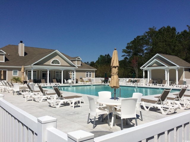 view of swimming pool featuring a patio area and an outdoor structure