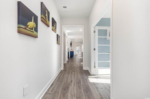 hall with hardwood / wood-style flooring