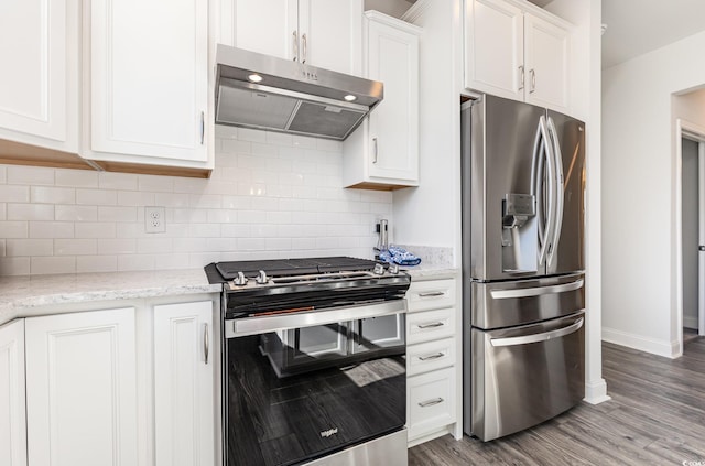 kitchen with light stone countertops, stainless steel appliances, tasteful backsplash, hardwood / wood-style floors, and white cabinets