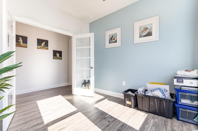 miscellaneous room with hardwood / wood-style floors and french doors