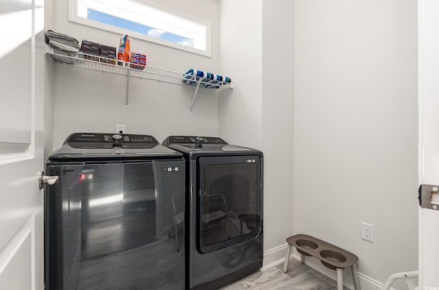 clothes washing area with washing machine and dryer