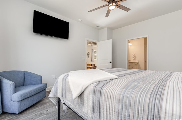 bedroom with ensuite bath, ceiling fan, and hardwood / wood-style floors