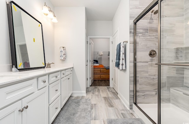 bathroom with vanity, wood-type flooring, and walk in shower