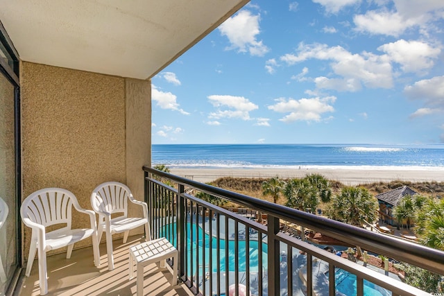 balcony with a view of the beach and a water view