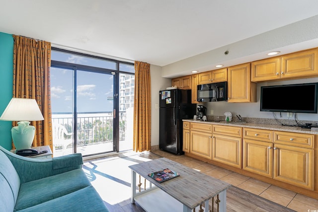 living room with light tile patterned floors and expansive windows