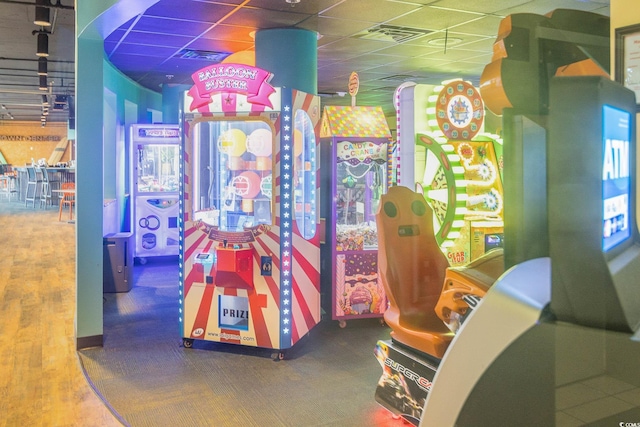 game room with a drop ceiling and visible vents