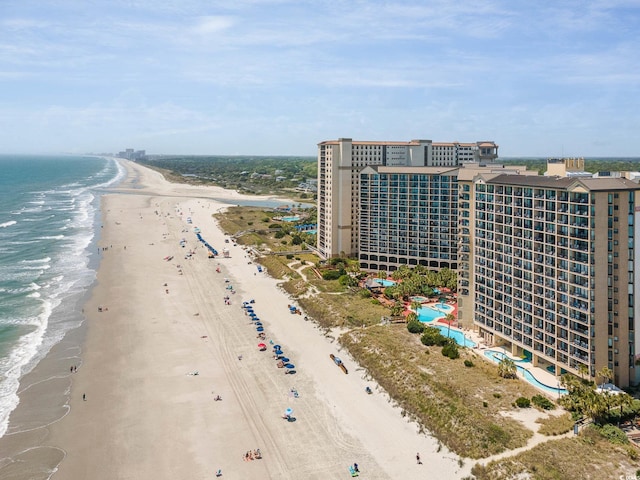 drone / aerial view featuring a view of the beach and a water view