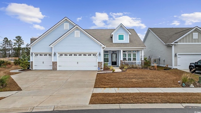 view of front of house with covered porch and a garage