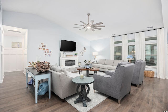 living room featuring vaulted ceiling, ceiling fan, and dark hardwood / wood-style floors