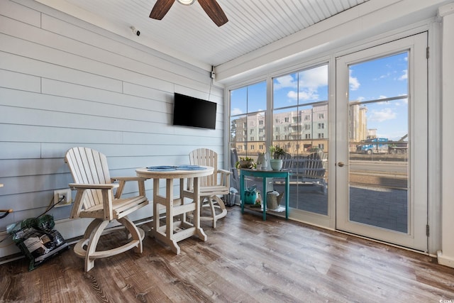 sunroom / solarium featuring ceiling fan