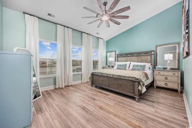 bedroom featuring ceiling fan, light hardwood / wood-style flooring, and vaulted ceiling