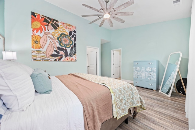 bedroom featuring light wood-type flooring and ceiling fan