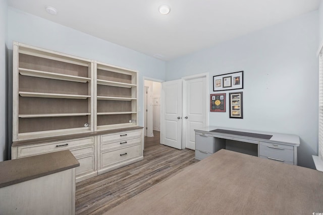 unfurnished bedroom with dark wood-type flooring