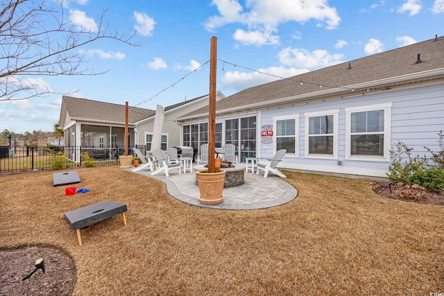 back of property with a yard and a patio