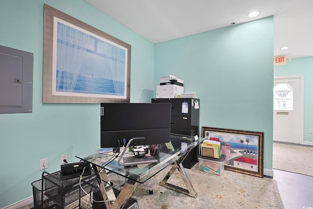 home office featuring concrete flooring and electric panel