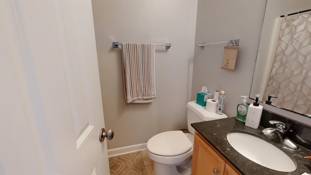 bathroom with tile patterned flooring, vanity, and toilet