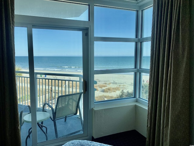 bedroom with a water view and a beach view