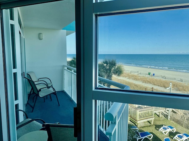 balcony with a beach view and a water view