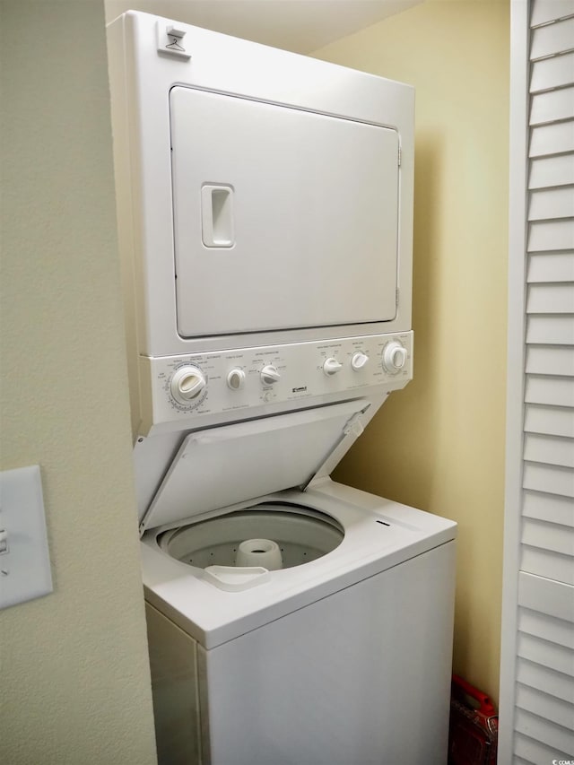 laundry room with stacked washer / dryer