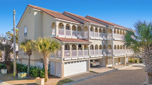 view of front facade featuring a balcony and a garage