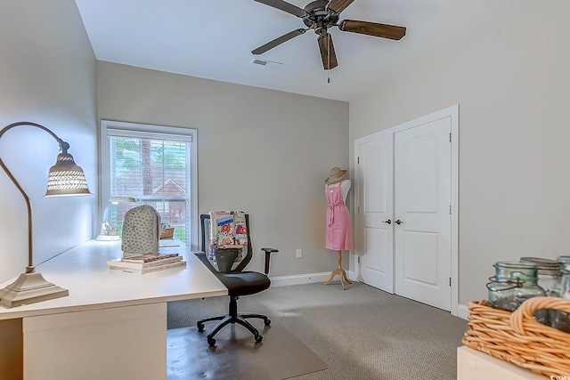 carpeted home office featuring ceiling fan