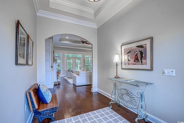 interior space featuring french doors, a raised ceiling, crown molding, ceiling fan, and dark hardwood / wood-style flooring