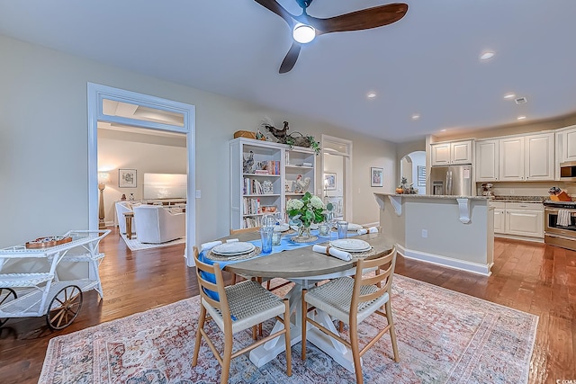 dining space with light hardwood / wood-style floors and ceiling fan