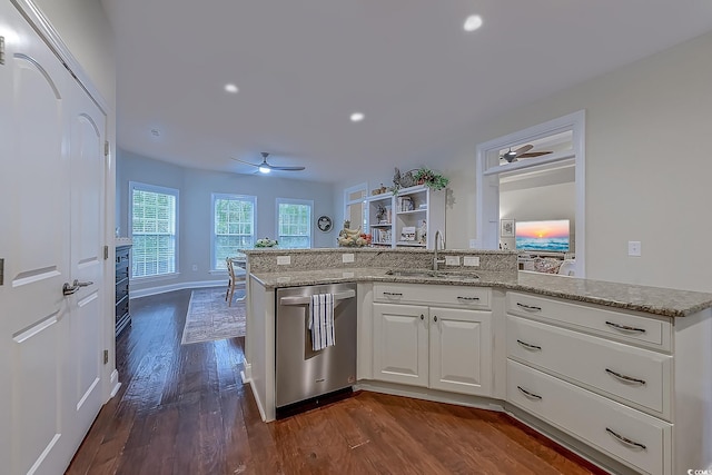 kitchen with white cabinets, sink, stainless steel dishwasher, ceiling fan, and light stone countertops