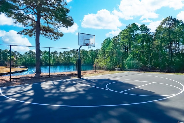 view of basketball court featuring a water view