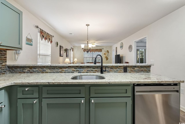 kitchen featuring dishwasher, light stone countertops, green cabinets, and sink