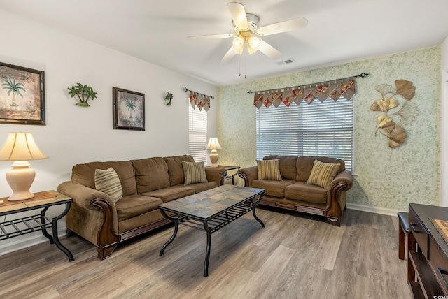 living room with wood-type flooring and ceiling fan