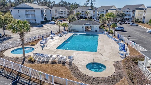 view of pool featuring a patio area and a hot tub